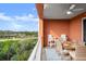 Balcony with outdoor seating and views of trees and waterway, creating a tranquil space at 2 Riverwalk Dr # 402, New Smyrna Beach, FL 32169