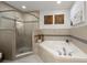 Luxurious bathroom featuring a tiled shower, soaking tub, and modern fixtures at 2 Riverwalk Dr # 402, New Smyrna Beach, FL 32169