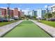 Bocce ball court set between colorful condominium buildings and parking at 2 Riverwalk Dr # 402, New Smyrna Beach, FL 32169