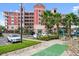 Exterior facade and entry with parking and shuffleboard court at 2 Riverwalk Dr # 402, New Smyrna Beach, FL 32169