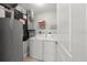 Neat laundry room featuring a washer, dryer, and storage shelves at 2 Riverwalk Dr # 402, New Smyrna Beach, FL 32169