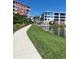 Scenic walkway and relaxing pond view with modern condo buildings in the background at 2 Riverwalk Dr # 402, New Smyrna Beach, FL 32169