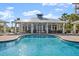 Exterior view of a pool with ample seating surrounded by a deck and covered patio at 2 Riverwalk Dr # 402, New Smyrna Beach, FL 32169