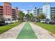 Community shuffleboard court among condo buildings, parking, and landscaping at 2 Riverwalk Dr # 402, New Smyrna Beach, FL 32169