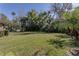 Large backyard with lush green grass and mature trees at 2232 Swoope Dr, New Smyrna Beach, FL 32168