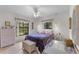 Cozy bedroom with cool-colored walls, light-colored floors, a ceiling fan, and large windows to let in natural light at 2232 Swoope Dr, New Smyrna Beach, FL 32168