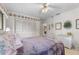 Bright bedroom with light-colored floors, closet, ceiling fan and neutral walls at 2232 Swoope Dr, New Smyrna Beach, FL 32168