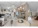 Eat-in kitchen features white cabinets, tile floor, a brick accent wall, and a chandelier at 2232 Swoope Dr, New Smyrna Beach, FL 32168