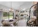 Bright eat-in kitchen featuring white cabinetry, tile flooring, and sliding glass doors to the backyard at 2232 Swoope Dr, New Smyrna Beach, FL 32168