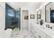 Spa-like bathroom with double vanity and blue tile shower at 224 Condict Dr, New Smyrna Beach, FL 32169