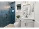 Modern bathroom with blue tile shower and white vanity at 224 Condict Dr, New Smyrna Beach, FL 32169