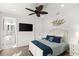 Bright bedroom with ceiling fan and ensuite bathroom at 224 Condict Dr, New Smyrna Beach, FL 32169