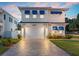 Stunning two-story home with blue accents and a brick driveway at 224 Condict Dr, New Smyrna Beach, FL 32169