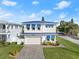 Two-story home with blue accents and a paved driveway at 224 Condict Dr, New Smyrna Beach, FL 32169