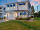 Two-story home with blue accents and a charming front yard at 224 Condict Dr, New Smyrna Beach, FL 32169