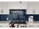 Modern kitchen with gas range and blue tile backsplash at 224 Condict Dr, New Smyrna Beach, FL 32169