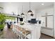 Modern kitchen with white cabinets, a large island, and blue tile backsplash at 224 Condict Dr, New Smyrna Beach, FL 32169