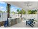 Modern outdoor kitchen with stainless steel appliances and seating at 224 Condict Dr, New Smyrna Beach, FL 32169