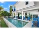 Inviting pool with blue lounge chairs and fire pit at 224 Condict Dr, New Smyrna Beach, FL 32169