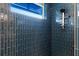 Modern shower with blue tile and glass enclosure at 224 Condict Dr, New Smyrna Beach, FL 32169