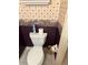 A half-bath with an ornate wallpaper design and a standard toilet at 2259 Candlewood E Ln, New Smyrna Beach, FL 32168