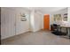 A versatile bedroom with neutral carpet, a desk, and a brightly colored door at 229 Columbus Ave, Daytona Beach, FL 32118