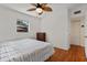 Comfortable bedroom featuring hardwood floors, a ceiling fan, and a bright window at 229 Columbus Ave, Daytona Beach, FL 32118