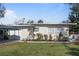 Charming single-story home with manicured front lawn and carport in a residential neighborhood at 229 Columbus Ave, Daytona Beach, FL 32118