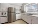 Well-lit kitchen with stainless steel appliances and white cabinets at 229 Columbus Ave, Daytona Beach, FL 32118