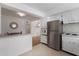 Open kitchen area with stainless steel refrigerator and breakfast bar at 229 Columbus Ave, Daytona Beach, FL 32118