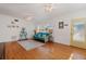 Well-lit living room with hardwood floors, a cozy futon, and stylish decor that leads to a yellow entry door at 229 Columbus Ave, Daytona Beach, FL 32118