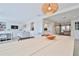 Bright dining room features a light wood table and stylish light fixture at 2307 Saxon Dr, New Smyrna Beach, FL 32169