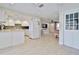 Modern white kitchen with stainless steel appliances and mosaic backsplash at 2307 Saxon Dr, New Smyrna Beach, FL 32169