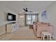 Living room with sectional sofa, TV, and whitewashed cabinet at 2307 Saxon Dr, New Smyrna Beach, FL 32169