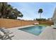 Inviting pool with wooden fence and lounge chairs at 2307 Saxon Dr, New Smyrna Beach, FL 32169