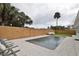 Modern pool and patio with wood fence at 2307 Saxon Dr, New Smyrna Beach, FL 32169