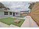 Relaxing pool area with patio furniture and modern fence at 2307 Saxon Dr, New Smyrna Beach, FL 32169