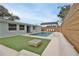 Relaxing pool area with patio furniture and modern fence at 2307 Saxon Dr, New Smyrna Beach, FL 32169