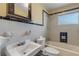 Bathroom with white and blue tile and a shower/tub combo at 2515 Fairfax Ave, New Smyrna Beach, FL 32168