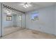 Bedroom with mirrored closet doors and window at 2515 Fairfax Ave, New Smyrna Beach, FL 32168