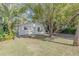 House exterior showcasing a light-colored home and yard at 2515 Fairfax Ave, New Smyrna Beach, FL 32168