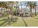 Single story home with screened porch and palm trees at 2515 Fairfax Ave, New Smyrna Beach, FL 32168