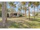 Single story home with screened porch and palm trees at 2515 Fairfax Ave, New Smyrna Beach, FL 32168