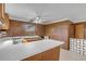 L-shaped kitchen with wood cabinets and white countertops at 2515 Fairfax Ave, New Smyrna Beach, FL 32168