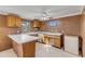 L-shaped kitchen with wood cabinets and white countertops at 2515 Fairfax Ave, New Smyrna Beach, FL 32168