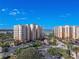 Aerial view of two condo buildings, showing parking and landscaping at 265 Minorca Beach Way # 204, New Smyrna Beach, FL 32169