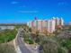 Aerial view of Smyrna Dunes Park, featuring a luxurious condo building near the ocean at 265 Minorca Beach Way # 204, New Smyrna Beach, FL 32169