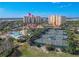 Aerial view of community pool, tennis courts, and clubhouse at 265 Minorca Beach Way # 204, New Smyrna Beach, FL 32169