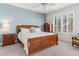 Spacious Primary bedroom with wood furniture and large window at 265 Minorca Beach Way # 204, New Smyrna Beach, FL 32169