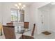 Bright dining area with glass table and wicker chairs at 265 Minorca Beach Way # 204, New Smyrna Beach, FL 32169